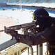 An Olympic guard in face mask watches over a stadium in Seoul, South Korea armed with an automatic rifle in 1988. (AP Photo)